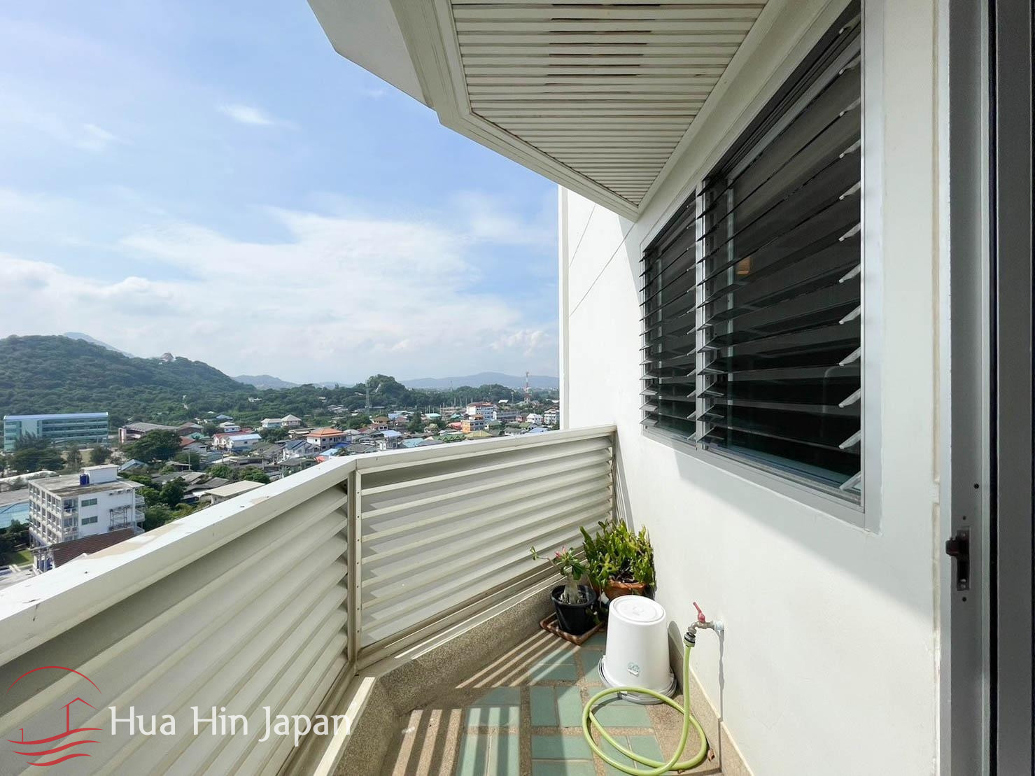 Apartment balcony with outdoor seating and mountain views