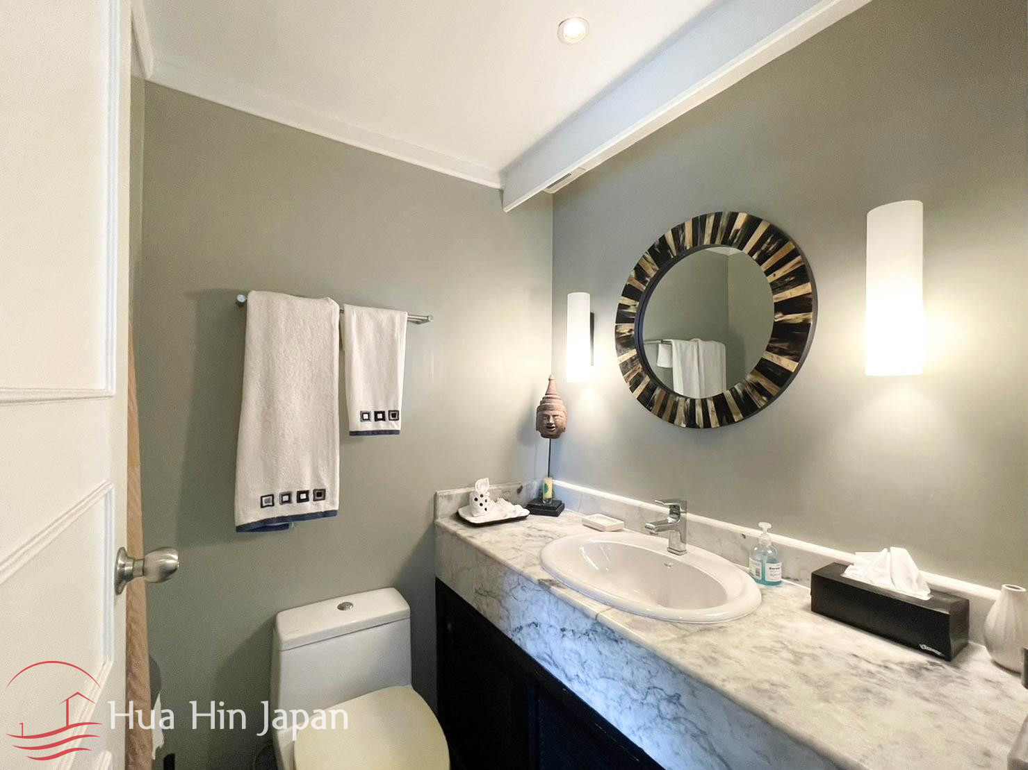 Contemporary bathroom vanity with round mirror and sink