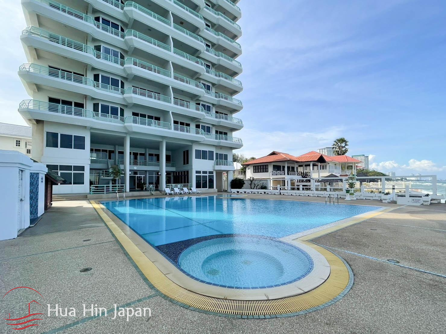 Resort swimming pool with circular section and modern residential building