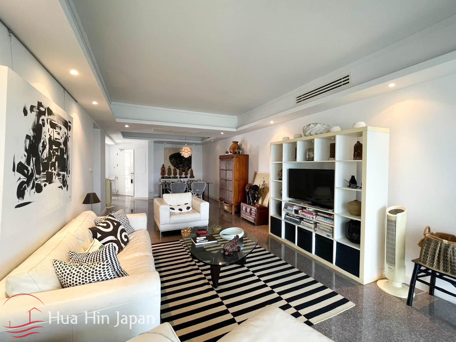 Spacious apartment living area with sofa, TV, and modern furnishings
