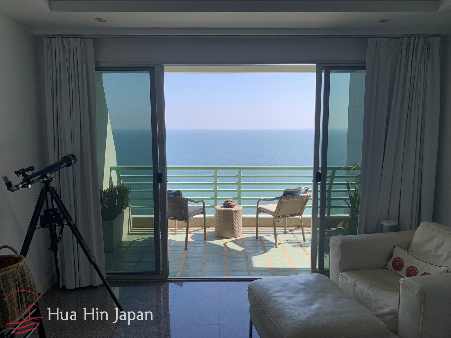 Ocean view from apartment balcony with outdoor seating