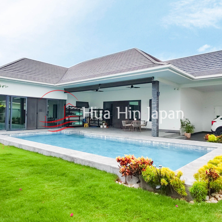 Modern single-story villa with a private swimming pool, covered patio, landscaped garden, and carport
