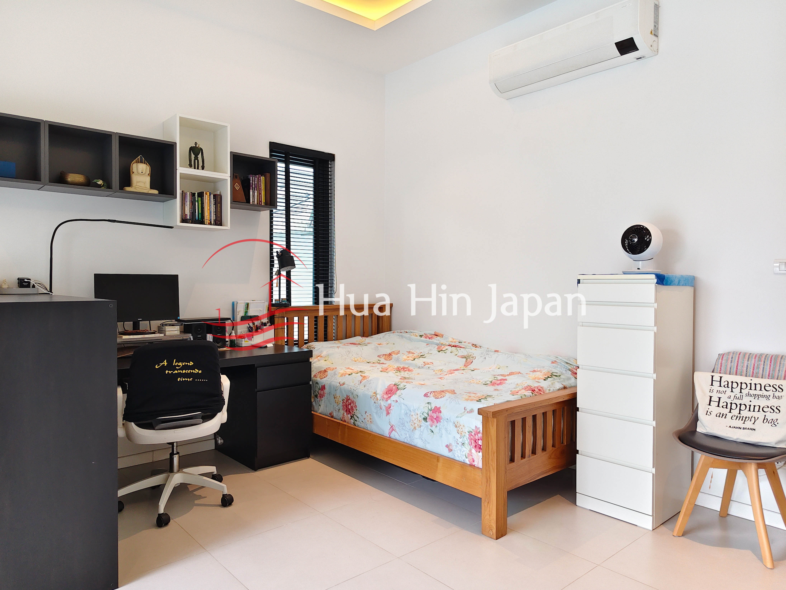 Bright modern bedroom with wooden bed, desk, bookshelf and air conditioner
