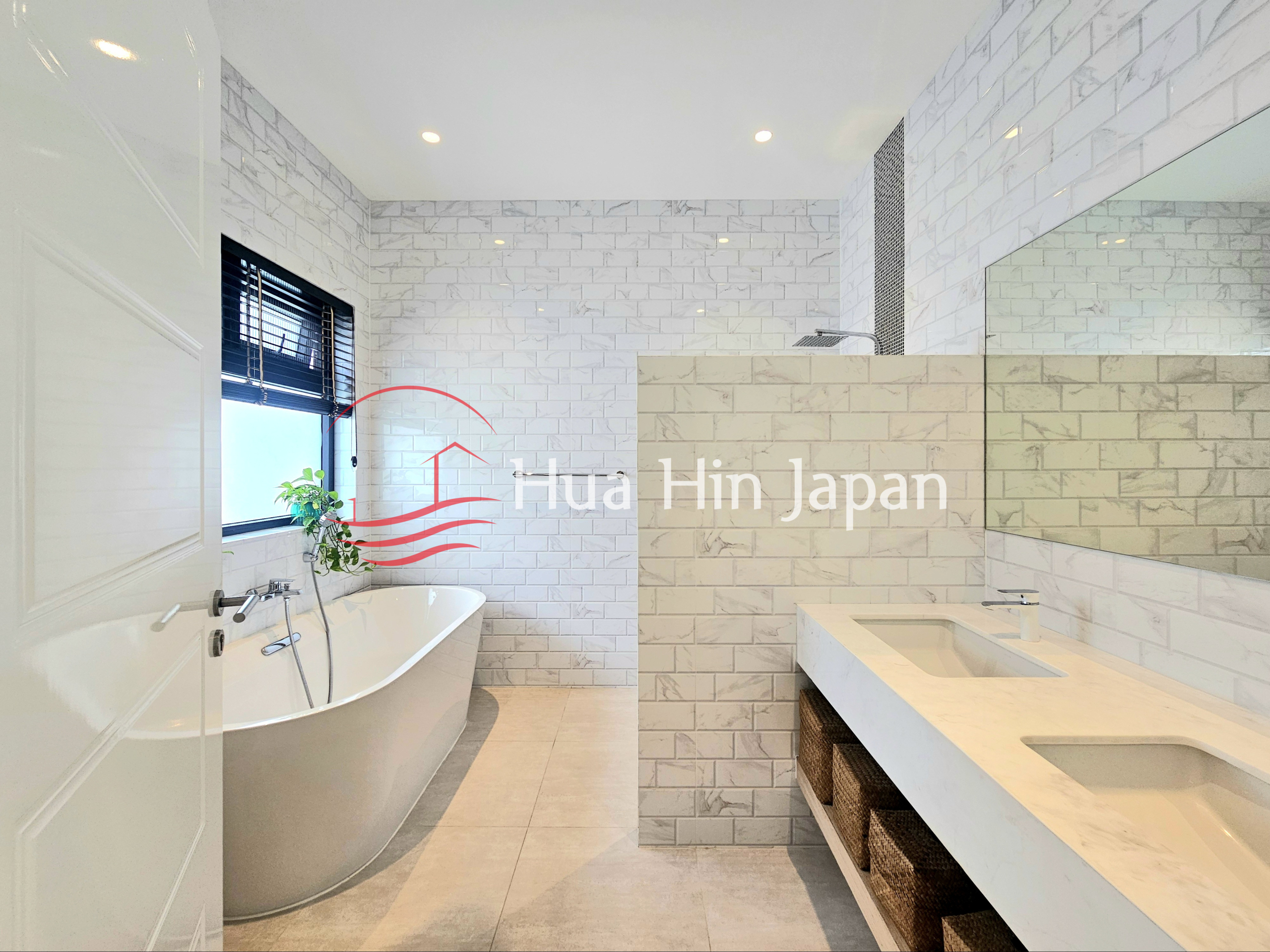 Bright modern bathroom with a freestanding bathtub, walk-in shower, and double vanity
