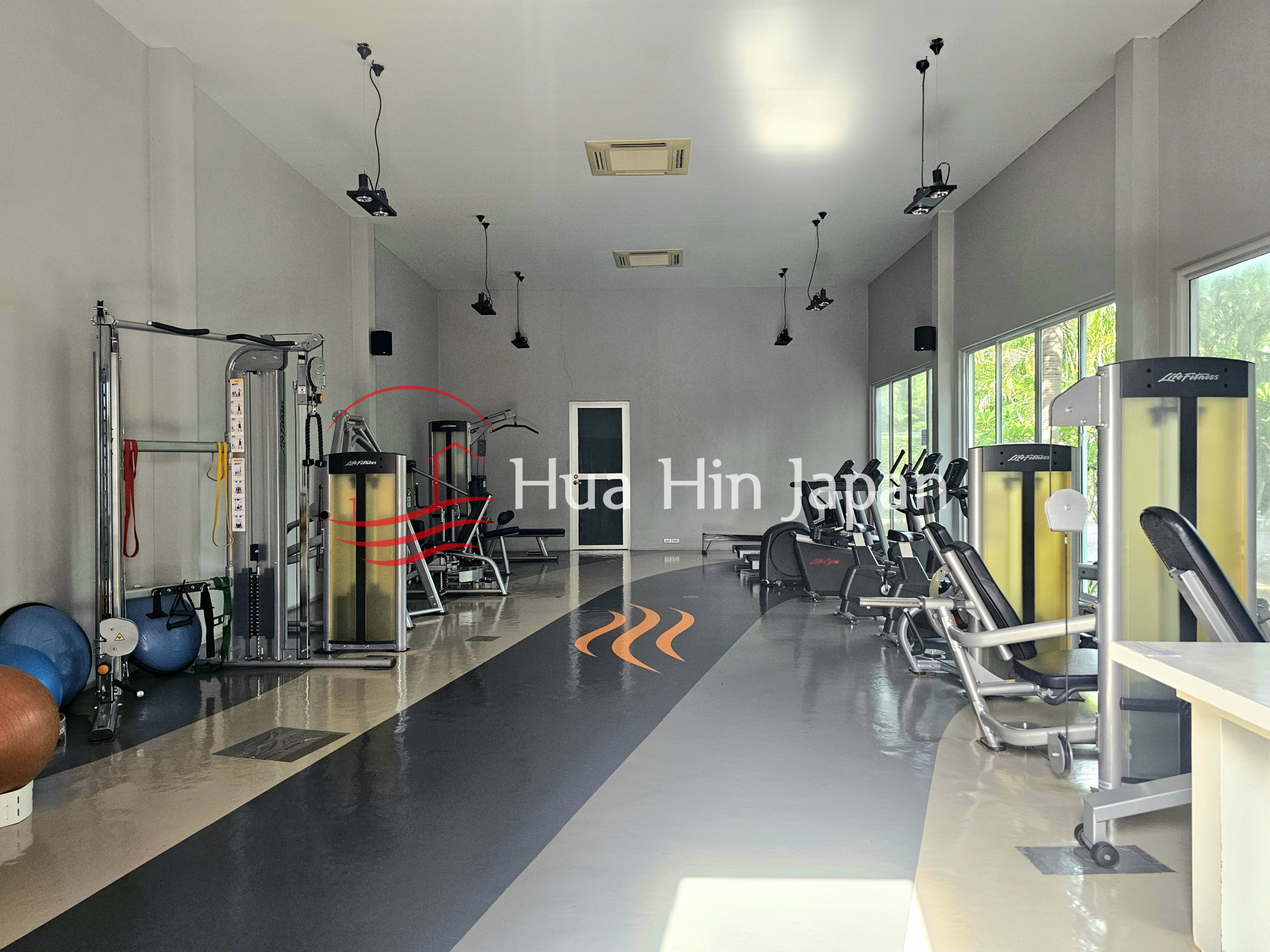 Spacious modern fitness center with cardio and strength training equipment