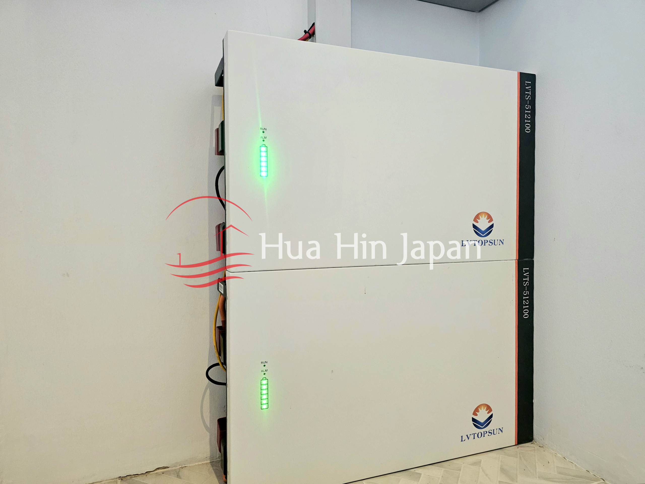 Two white LVTOPSUN solar energy storage units with green status indicators installed indoors