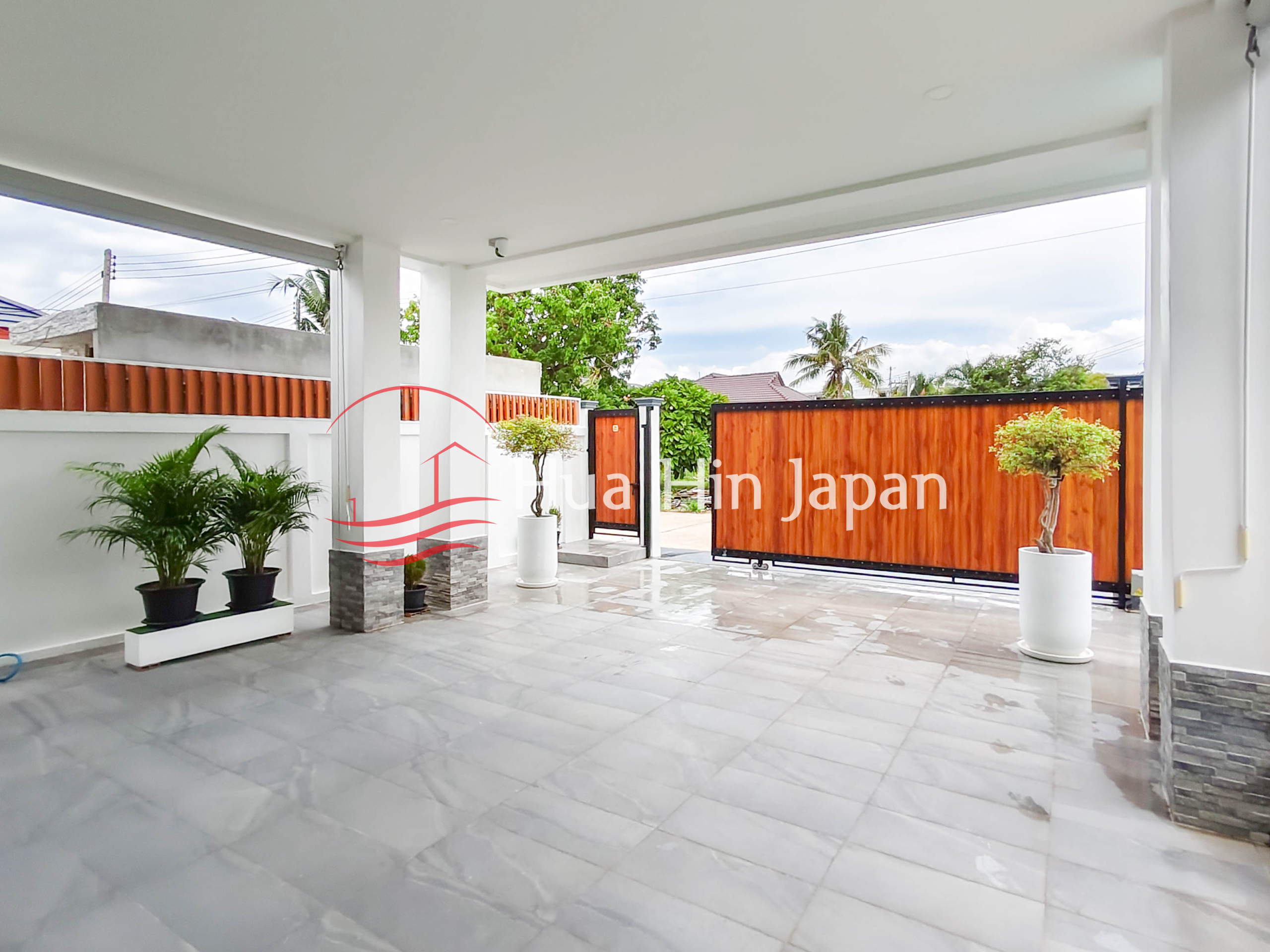 Modern villa outdoor patio with swimming pool, covered terrace, and landscaped garden
