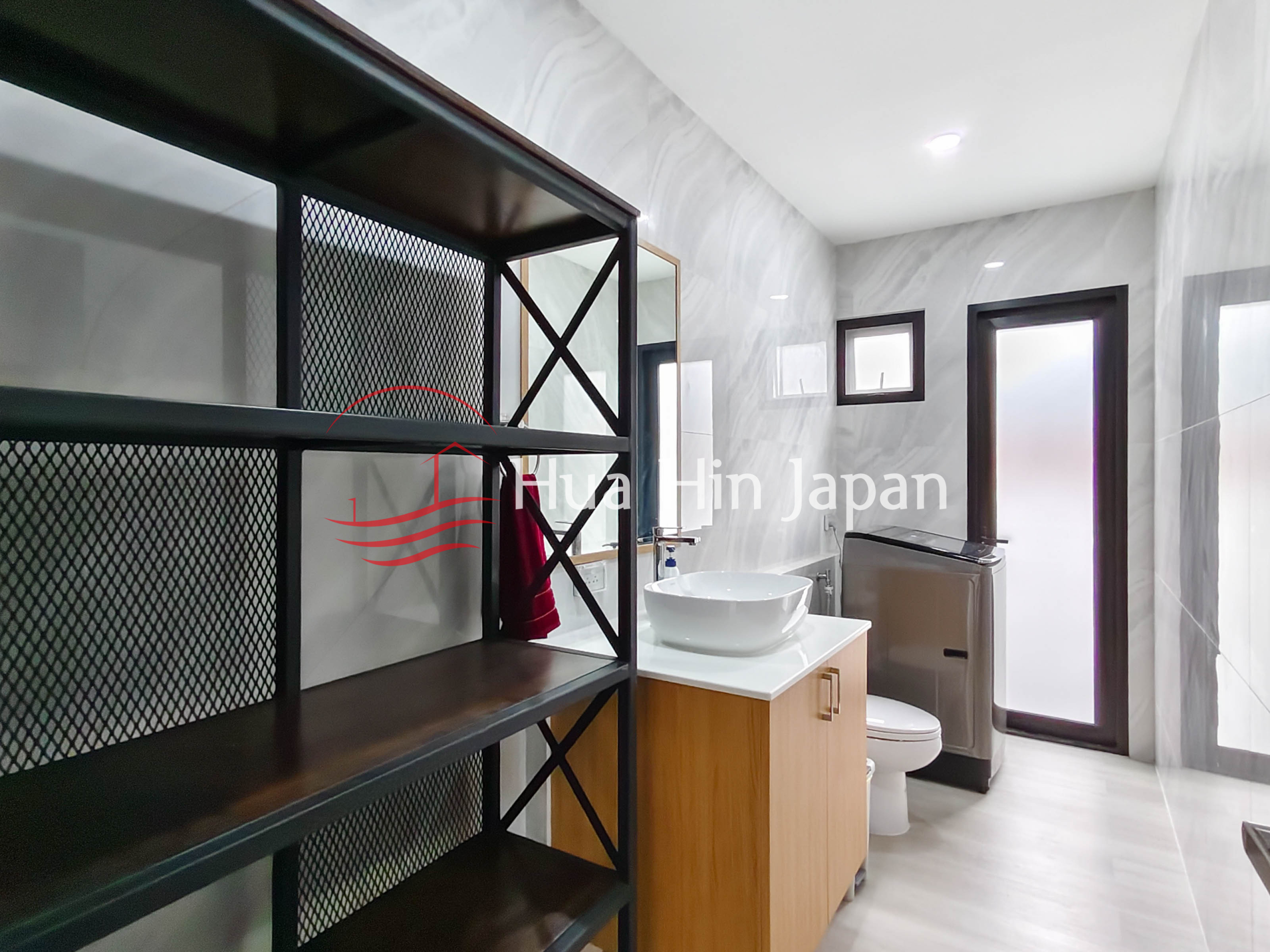 Modern bathroom with glass shower enclosure, vanity area, window, and storage