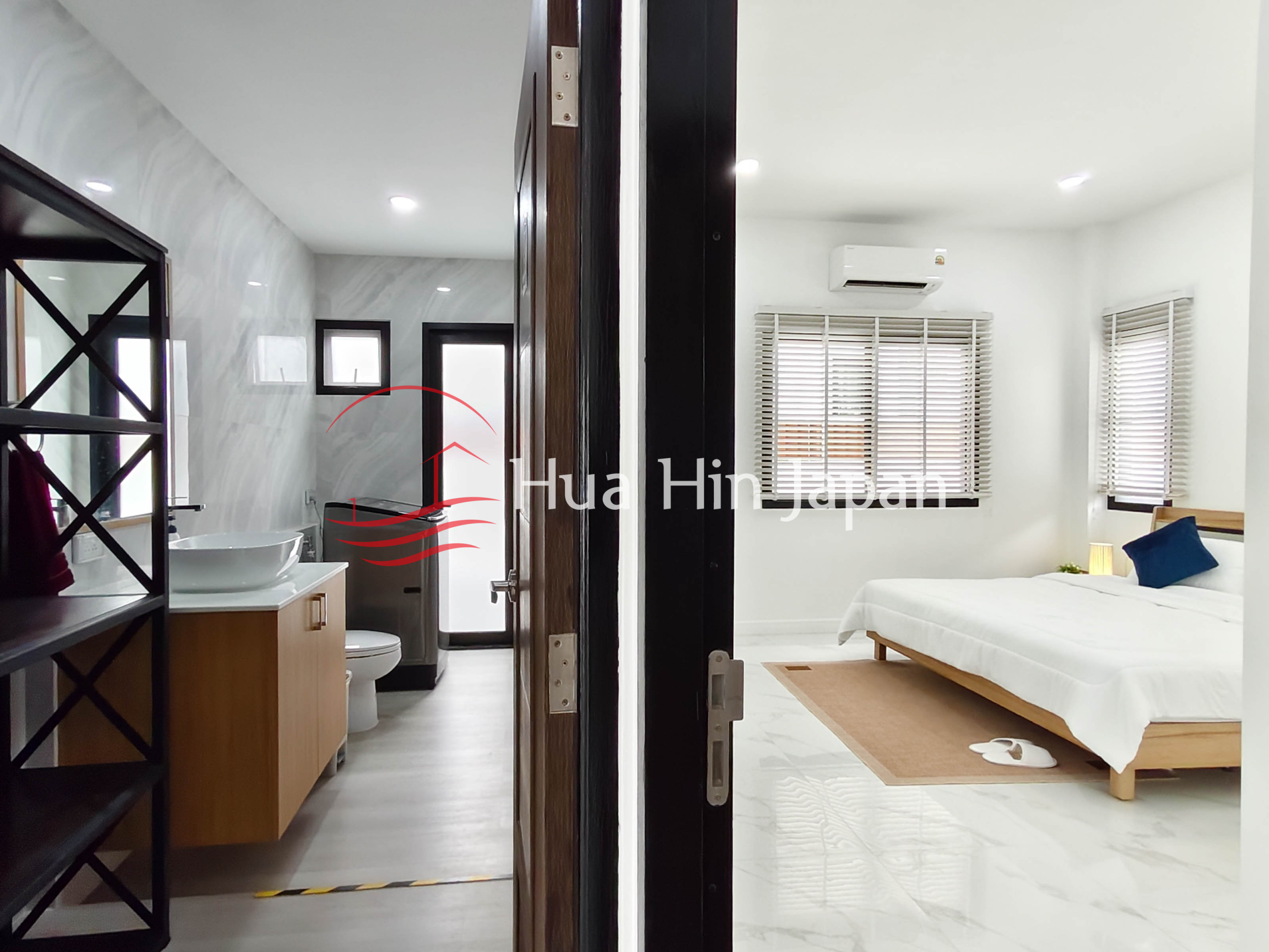 Modern bedroom interior with large window, curtains, wardrobe, and air conditioner