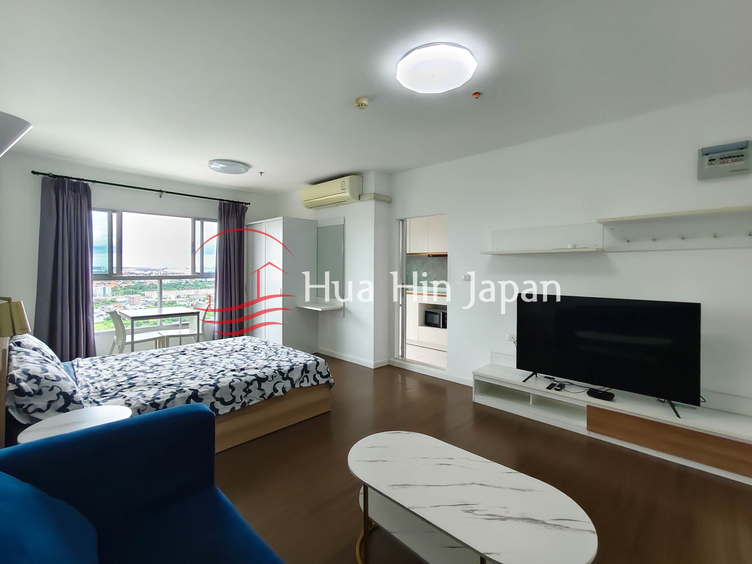 Studio room for sale at Baan Kieang Fha condominium drawing area sofa, tv, and bed