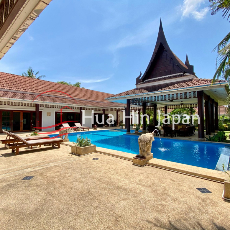 Traditional Thai-style villa with private swimming pool and tropical landscaping